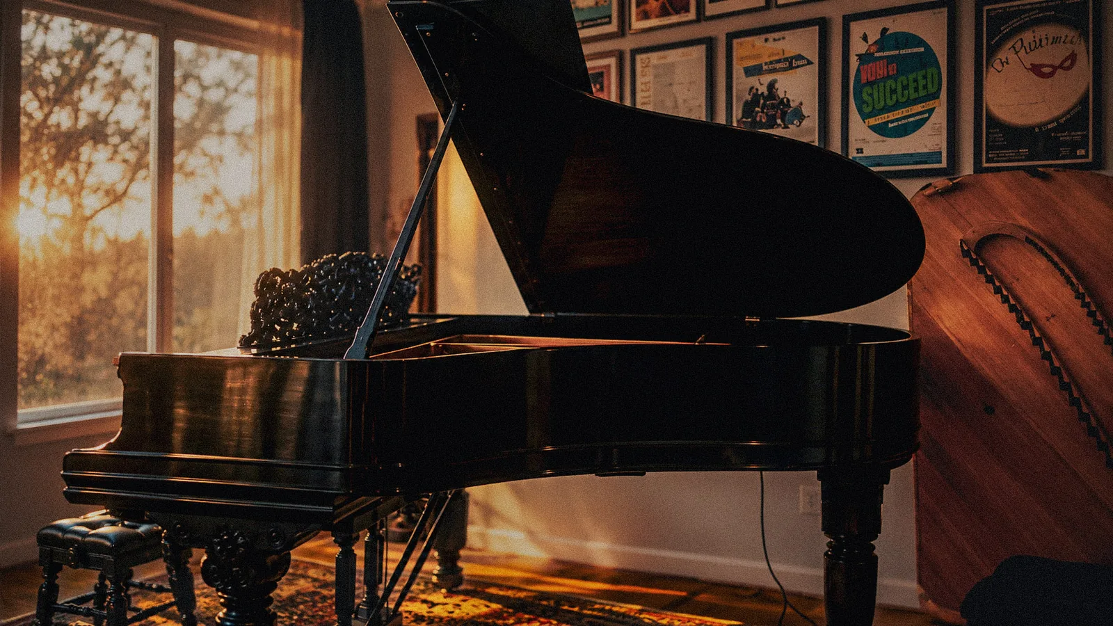 A black grand piano in a warmly lit room.